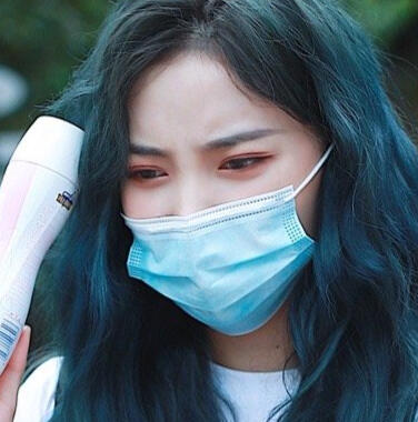 su ruiqi wearing face mask holding a yogurt drink bottle